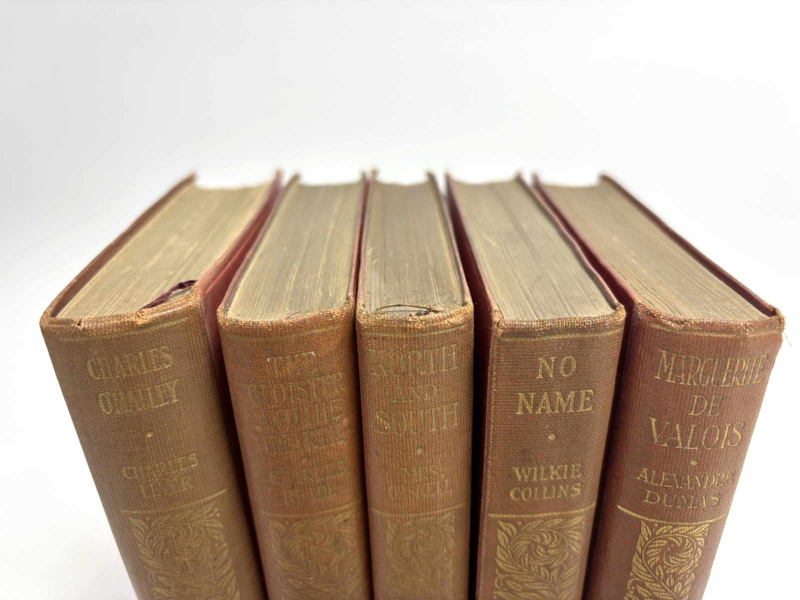 Collection of Small Old Books for Decoration. 12cm shelf space. 15.5cm Tall