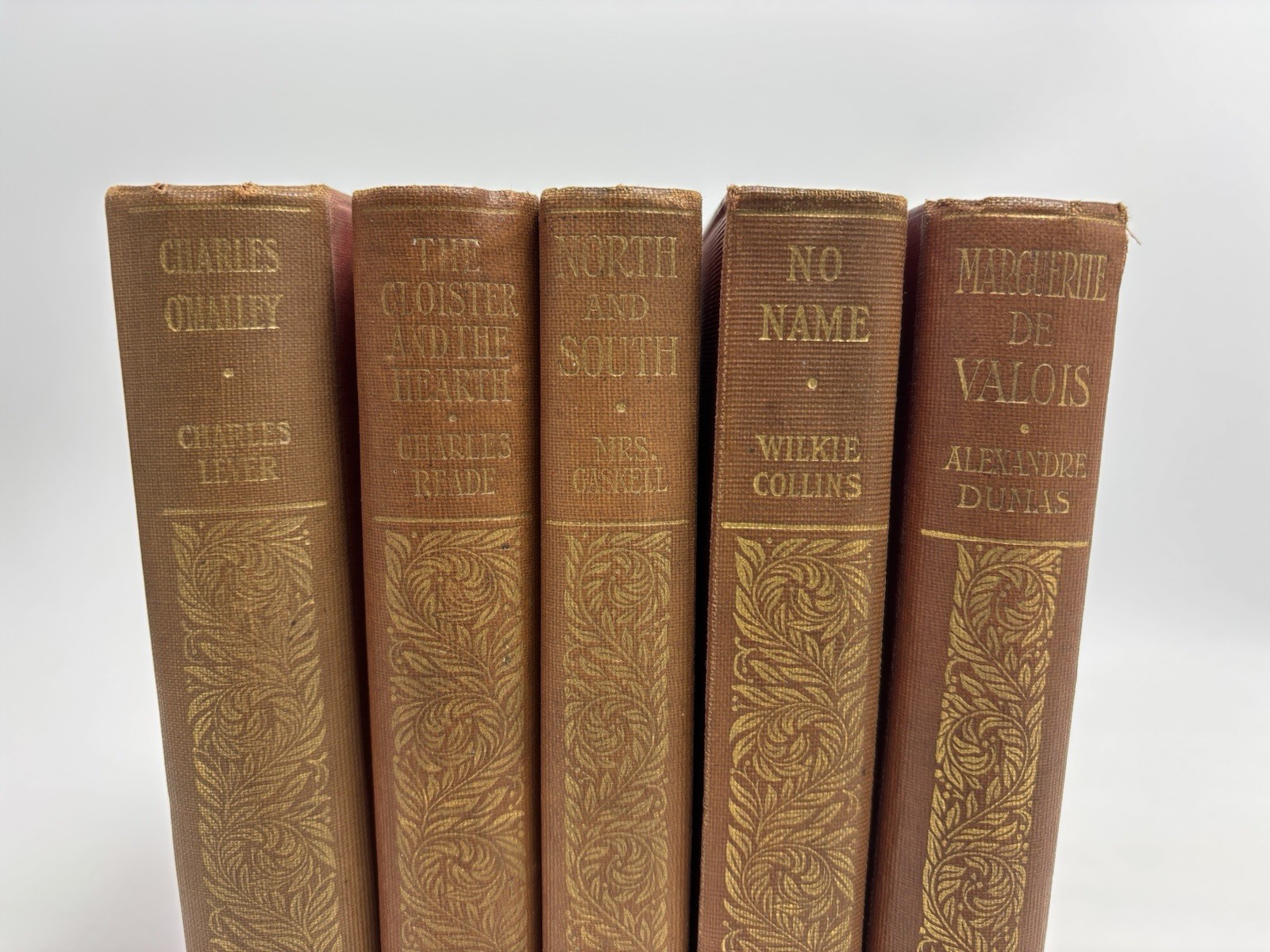 Collection of Small Old Books for Decoration. 12cm shelf space. 15.5cm Tall