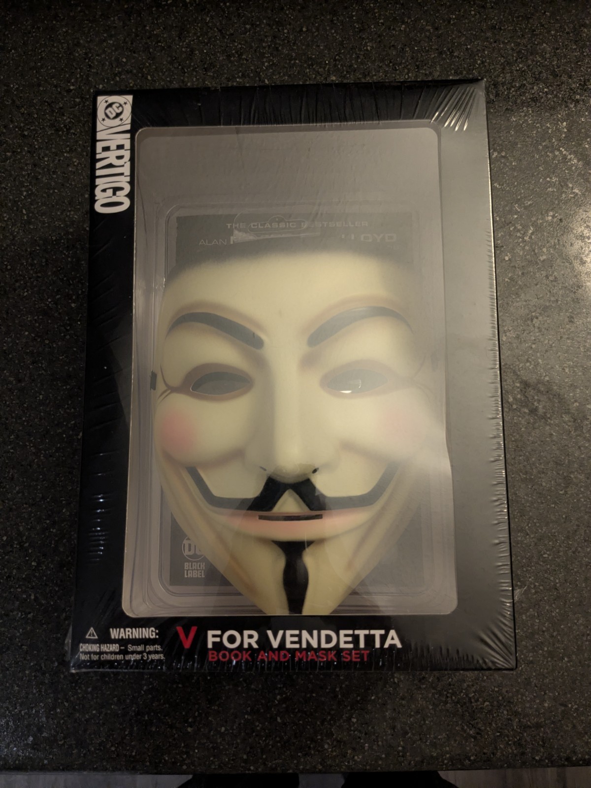 V for Vendetta graphic novel by Alan Moore and a Guy Fawkes mask DC Comics (DMG)
